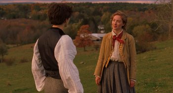 Movie still from “Little Women” (2019), directed by Greta Gerwig – Two people standing in a field with trees in the background; Medium shot, Over the shoulder angle
