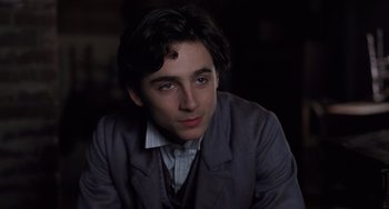 Movie still from “Little Women” (2019), directed by Greta Gerwig – A man in a suit and tie looking at the camera; Close Up shot, Over the shoulder angle
