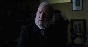 Movie still from “Little Women” (2019), directed by Greta Gerwig – An old man with a beard wearing a suit and tie; Close Up shot, Over the shoulder angle