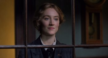 Movie still from “Little Women” (2019), directed by Greta Gerwig – A woman in a suit and tie behind a window; Close Up shot, Over the shoulder angle
