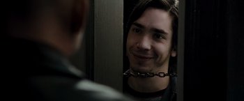 Movie still from “Live Free or Die Hard” (2007), directed by Len Wiseman – A man with a chain around his neck looking at himself in the mirror; Close Up shot, Over the shoulder angle