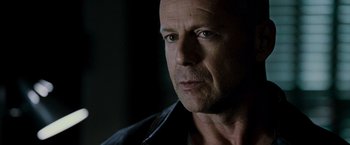 Movie still from “Live Free or Die Hard” (2007), directed by Len Wiseman – A man's face in the dark; Close Up shot, Over the shoulder angle