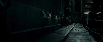 Movie still from “Live Free or Die Hard” (2007), directed by Len Wiseman – A dark street with a light on the side of the building; Extreme Wide shot, High angle