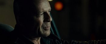 Movie still from “Live Free or Die Hard” (2007), directed by Len Wiseman – A person wearing a black jacket; Close Up shot, Over the shoulder angle