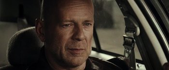 Movie still from “Live Free or Die Hard” (2007), directed by Len Wiseman – A man's face in a car; Close Up shot, Over the shoulder angle