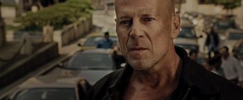 Movie still from “Live Free or Die Hard” (2007), directed by Len Wiseman – A person wearing a black shirt; Close Up shot, Low angle
