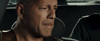 Movie still from “Live Free or Die Hard” (2007), directed by Len Wiseman – A man's face in a car; Close Up shot, Over the shoulder angle