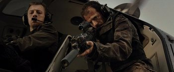 Movie still from “Live Free or Die Hard” (2007), directed by Len Wiseman – A man with a gun in a helicopter; Medium shot, Low angle
