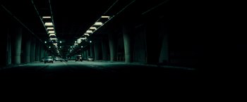 Movie still from “Live Free or Die Hard” (2007), directed by Len Wiseman – A car driving down a dark street at night; Extreme Wide shot, High angle
