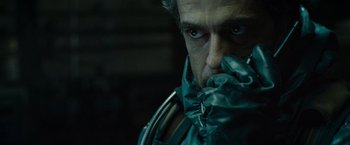 Movie still from “Live Free or Die Hard” (2007), directed by Len Wiseman – A person with a mask covering his face; Close Up shot, Over the shoulder angle