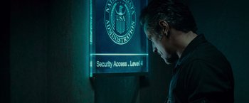 Movie still from “Live Free or Die Hard” (2007), directed by Len Wiseman – A man standing in front of a sign that says " security access level 4 "; Close Up shot, Over the shoulder angle