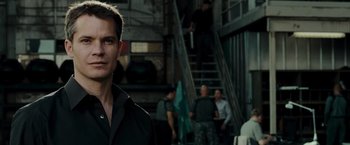 Movie still from “Live Free or Die Hard” (2007), directed by Len Wiseman – A man standing in front of a group of people; Close Up shot, Over the shoulder angle