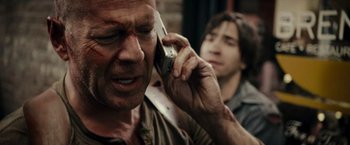 Movie still from “Live Free or Die Hard” (2007), directed by Len Wiseman – A person talking on a cell phone; Close Up shot, Over the shoulder angle