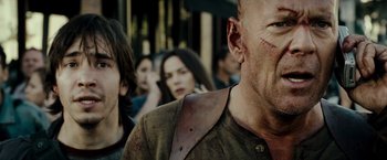 Movie still from “Live Free or Die Hard” (2007), directed by Len Wiseman – A person with a zombie face; Close Up shot, Over the shoulder angle