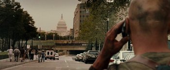 Movie still from “Live Free or Die Hard” (2007), directed by Len Wiseman – Cars parked on the side of the road near the capitol building; Extreme Close Up shot, Over the shoulder angle
