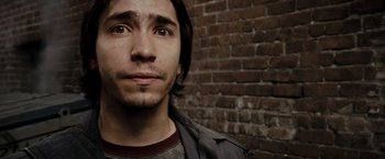 Movie still from “Live Free or Die Hard” (2007), directed by Len Wiseman – A person with a brick wall in the background; Close Up shot, High angle