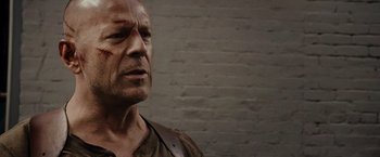 Movie still from “Live Free or Die Hard” (2007), directed by Len Wiseman – A person wearing a shirt; Close Up shot, Over the shoulder angle