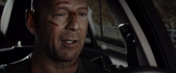Movie still from “Live Free or Die Hard” (2007), directed by Len Wiseman – A person with a scar on his face; Close Up shot, Over the shoulder angle