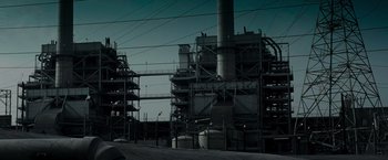 Movie still from “Live Free or Die Hard” (2007), directed by Len Wiseman – A large industrial building with many pipes on it's sides; Extreme Wide shot, Low angle
