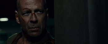 Movie still from “Live Free or Die Hard” (2007), directed by Len Wiseman – A man's face in the dark; Close Up shot, Low angle