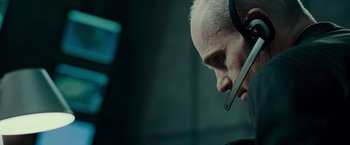 Movie still from “Live Free or Die Hard” (2007), directed by Len Wiseman – A man with a cell phone in his mouth; Close Up shot, Over the shoulder angle