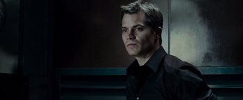 Movie still from “Live Free or Die Hard” (2007), directed by Len Wiseman – A man wearing a black shirt and a black shirt; Close Up shot, Low angle