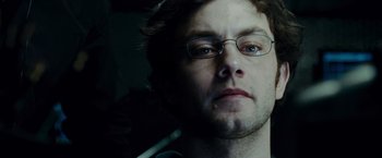 Movie still from “Live Free or Die Hard” (2007), directed by Len Wiseman – A person wearing glasses; Close Up shot, Low angle