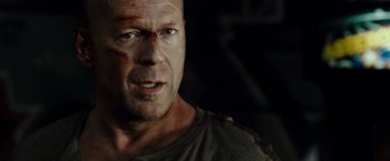 Movie still from “Live Free or Die Hard” (2007), directed by Len Wiseman – A man's face with blood on his face; Close Up shot, Over the shoulder angle