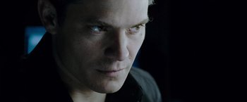 Movie still from “Live Free or Die Hard” (2007), directed by Len Wiseman – A man's face in a dark room; Close Up shot, Over the shoulder angle