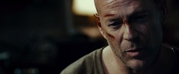 Movie still from “Live Free or Die Hard” (2007), directed by Len Wiseman – A person with a scar on his face; Close Up shot, Over the shoulder angle