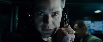 Movie still from “Live Free or Die Hard” (2007), directed by Len Wiseman – A person holding a cell phone to his ear; Close Up shot, Low angle