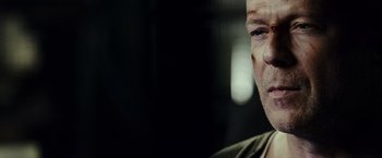 Movie still from “Live Free or Die Hard” (2007), directed by Len Wiseman – A person with a beard; Close Up shot, Over the shoulder angle