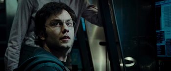 Movie still from “Live Free or Die Hard” (2007), directed by Len Wiseman – A person wearing glasses; Close Up shot, Over the shoulder angle