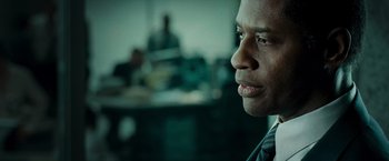 Movie still from “Live Free or Die Hard” (2007), directed by Len Wiseman – A person wearing a suit and tie; Close Up shot, Over the shoulder angle