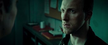 Movie still from “Live Free or Die Hard” (2007), directed by Len Wiseman – A person looking at the camera; Close Up shot, Over the shoulder angle