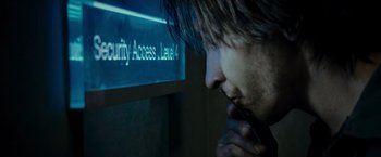 Movie still from “Live Free or Die Hard” (2007), directed by Len Wiseman – A man is looking at a sign on the wall; Extreme Close Up shot, Over the shoulder angle