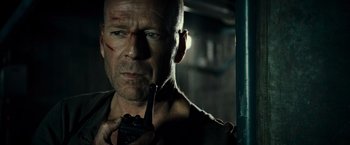 Movie still from “Live Free or Die Hard” (2007), directed by Len Wiseman – A man with a gun in his hand; Close Up shot, Low angle