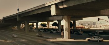 Movie still from “Live Free or Die Hard” (2007), directed by Len Wiseman – A car driving on a street under a bridge; Extreme Wide shot, High angle