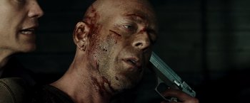 Movie still from “Live Free or Die Hard” (2007), directed by Len Wiseman – A person holding a knife with blood on it; Close Up shot, Low angle