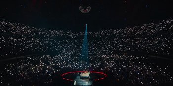 A large crowd of people in a dark room with lights