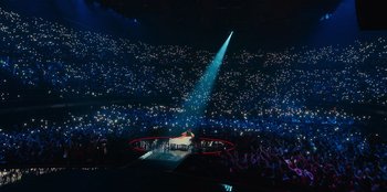 A large crowd of people in a dark room