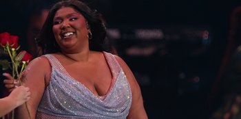 Movie still from “Lizzo: Live in Concert” (2022), directed by Brad Duns – A person wearing a dress; Close Up shot, Low angle