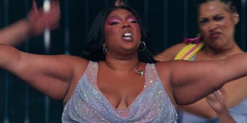 Movie still from “Lizzo: Live in Concert” (2022), directed by Brad Duns – A person wearing a dress; Close Up shot, Low angle