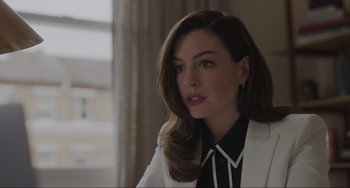 Movie still from “Locked Down” (2021), directed by Doug Liman – A woman with long hair wearing a white jacket; Close Up shot, Over the shoulder angle