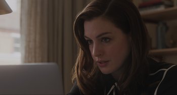 Movie still from “Locked Down” (2021), directed by Doug Liman – A person sitting at a table with a laptop; Close Up shot, Over the shoulder angle