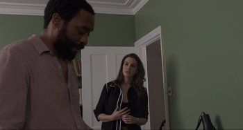 Movie still from “Locked Down” (2021), directed by Doug Liman – A man and a woman are standing in front of a mirror; Medium shot, Over the shoulder angle