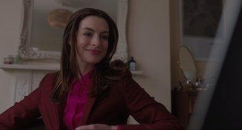 Movie still from “Locked Down” (2021), directed by Doug Liman – A woman in a pink shirt and a red jacket smiling; Close Up shot, Over the shoulder angle