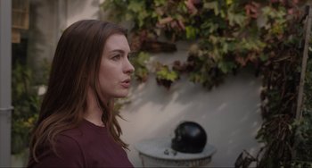 Movie still from “Locked Down” (2021), directed by Doug Liman – A woman standing in front of a wall with plants; Close Up shot, Over the shoulder angle