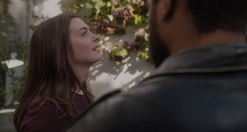 Movie still from “Locked Down” (2021), directed by Doug Liman – A woman standing next to a man in front of a tree; Close Up shot, Over the shoulder angle