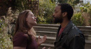 Movie still from “Locked Down” (2021), directed by Doug Liman – A man and a woman standing next to each other on some steps; Close Up shot, Over the shoulder angle